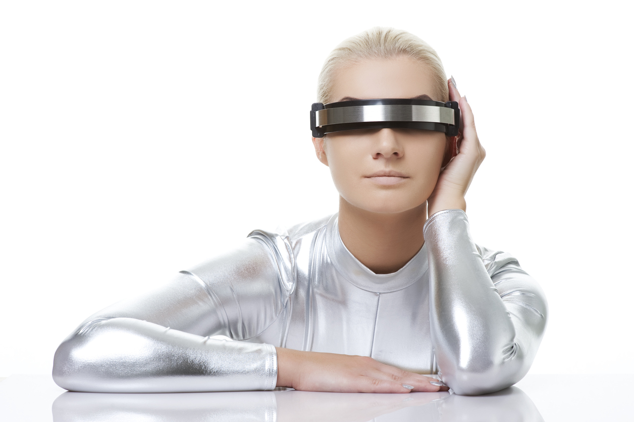 Female sat in silver suit and futurist glasses